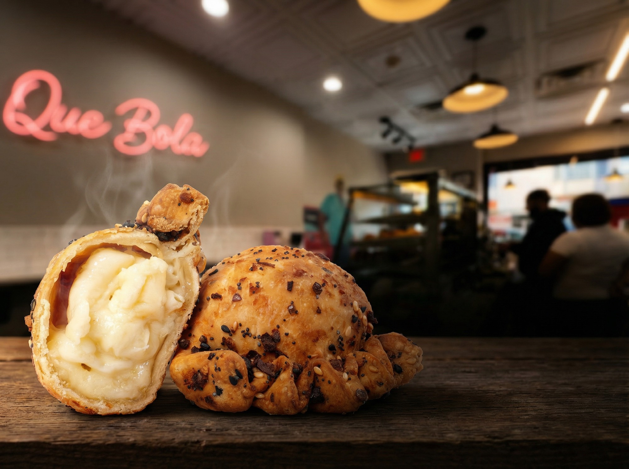 Cubita empanadas on the counter under the neon sign